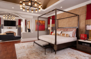 Bedroom with hints of red and custom bedding and pillows